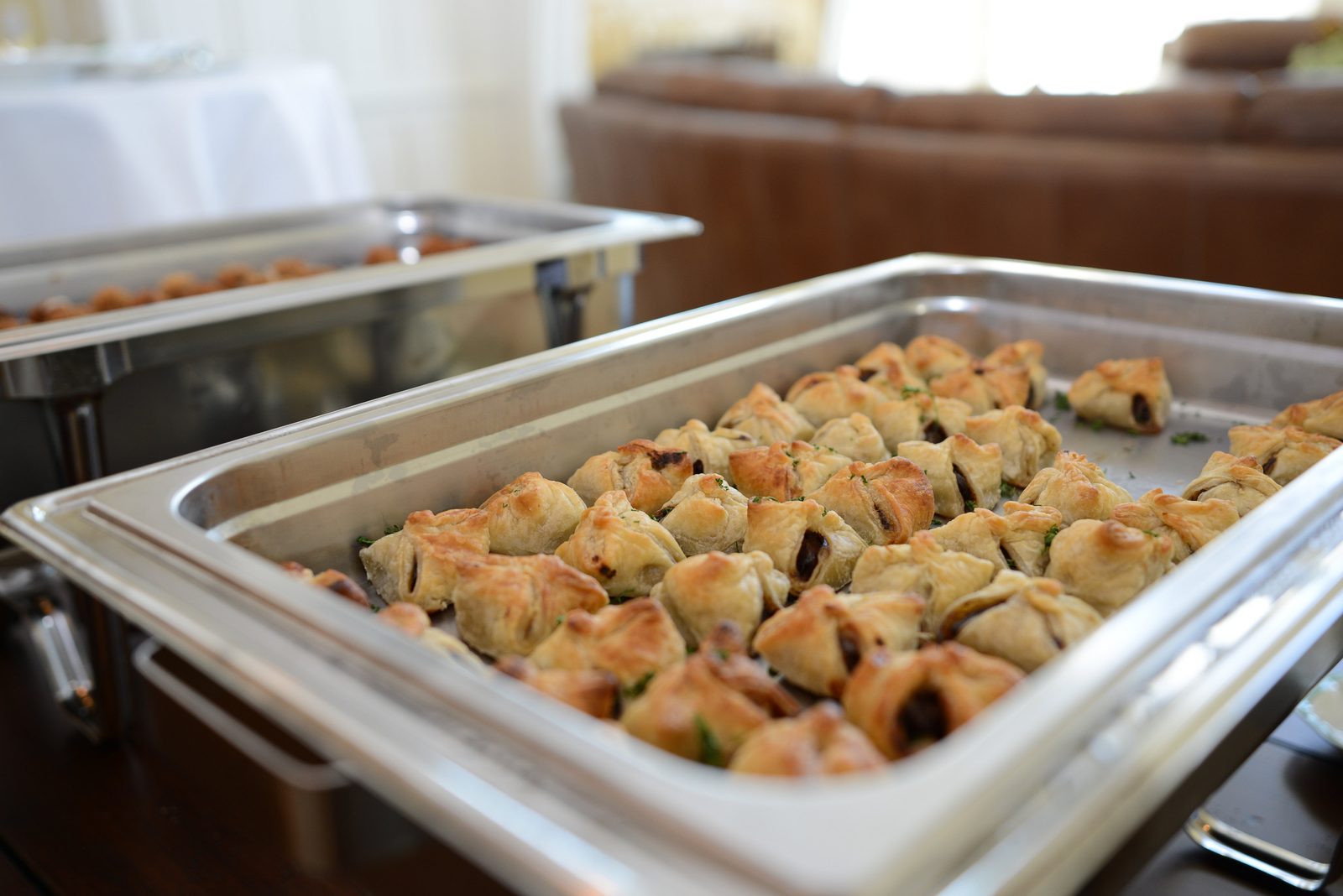 A table of catered refreshments including pastries, cookies and small plates (view 8)