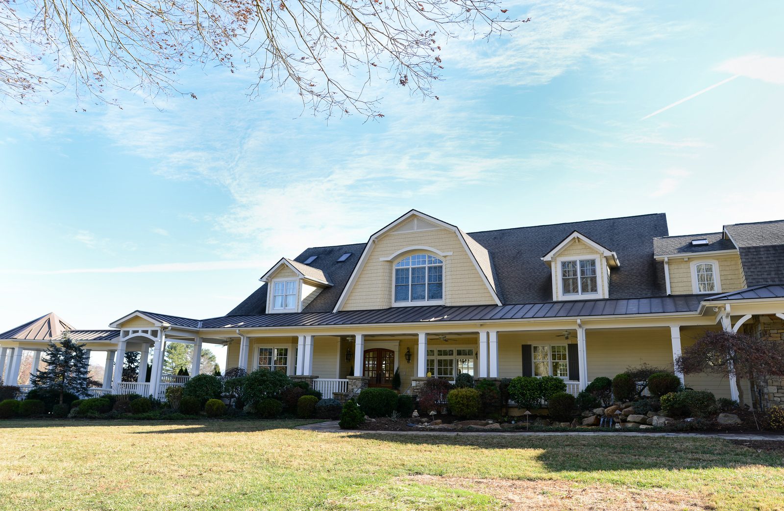 The Silver Ridge main residence seen from the front lawn, with a wraparound porch and dormer windows (view 1)