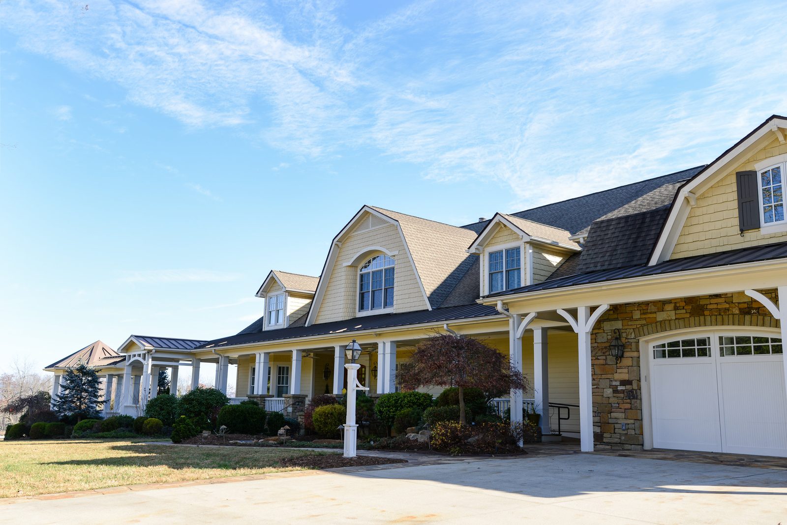 The Silver Ridge main residence seen from the front lawn, with a wraparound porch and dormer windows (view 2)