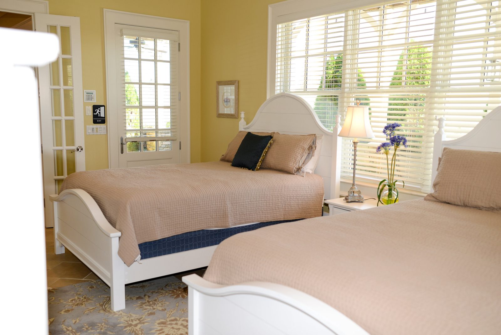 A guest room with two white beds, neutral linens and shuttered windows (view 3)