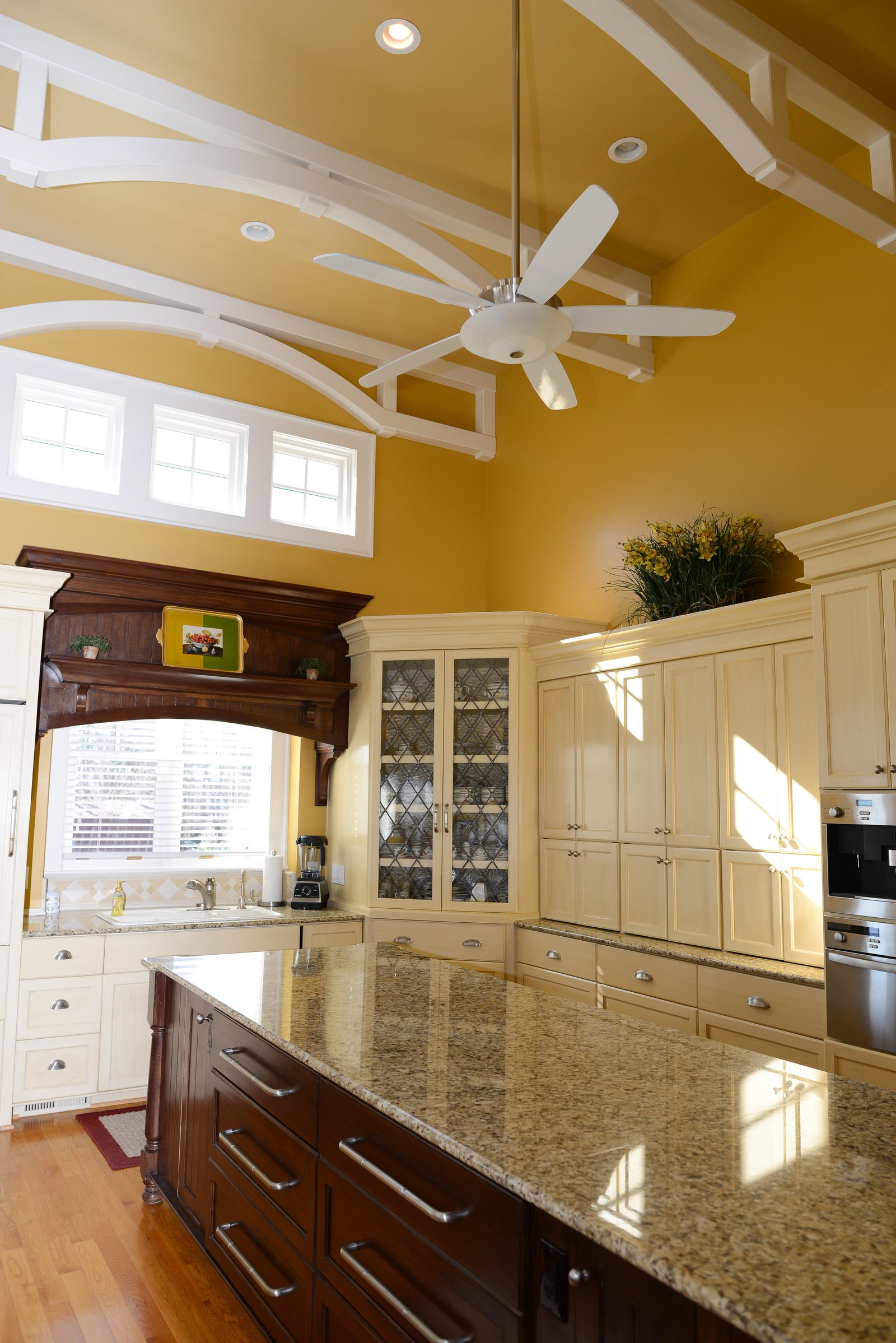 The main kitchen with cream cabinetry, a granite island and stainless appliances (view 4)