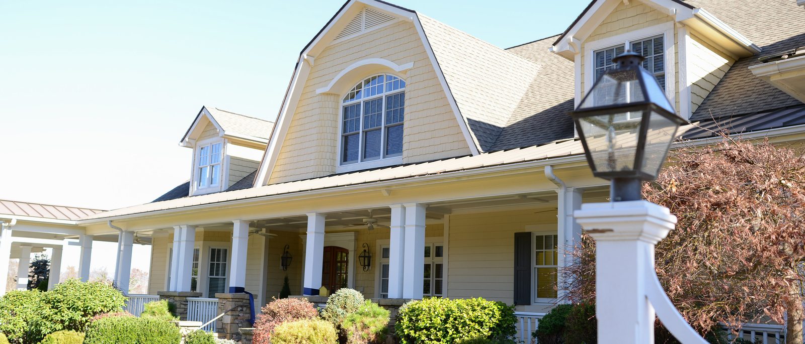 Close view of the Silver Ridge gables, porch columns and carriage lantern