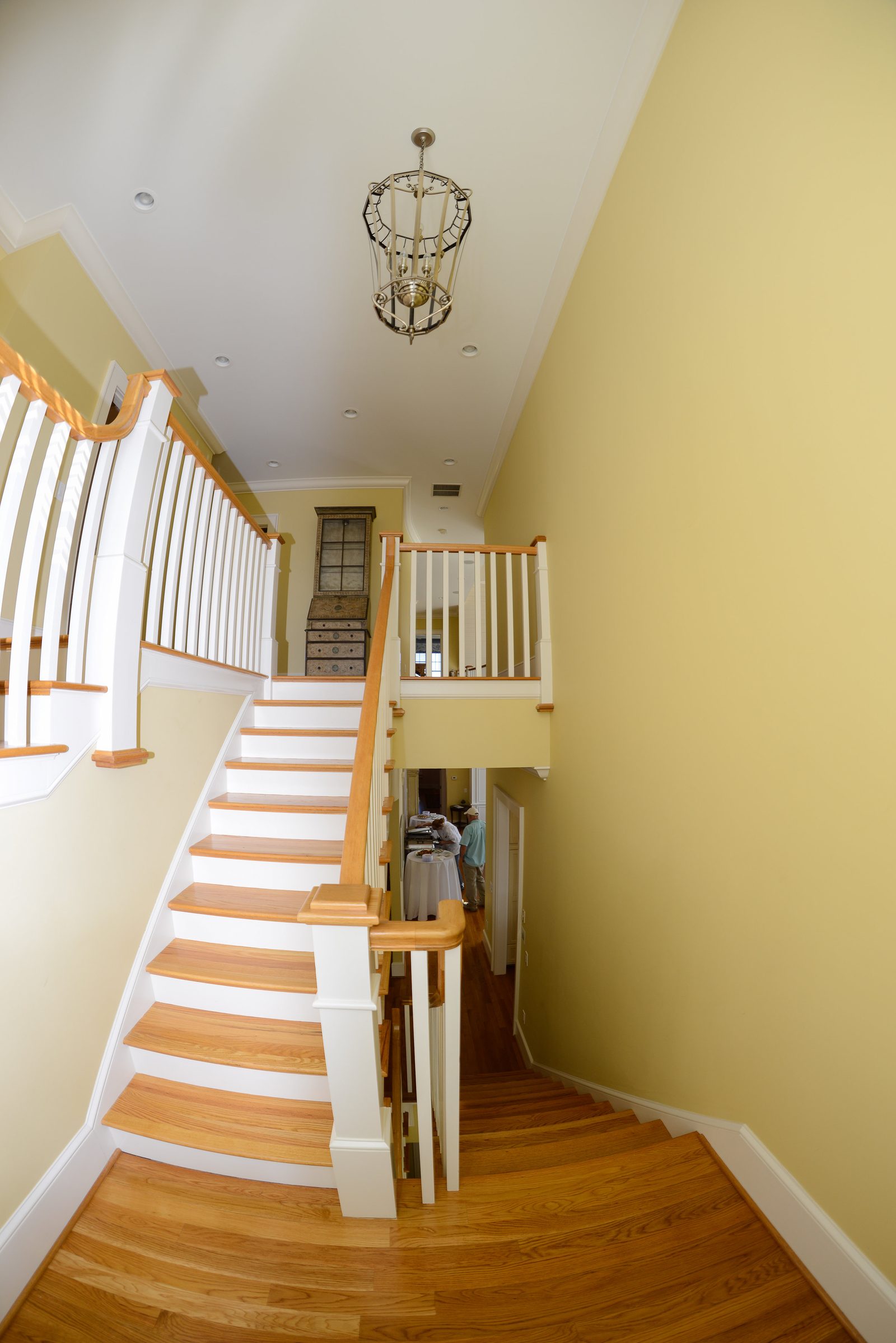 An open flight of stairs with a white railing overlooking the main floor (view 1)