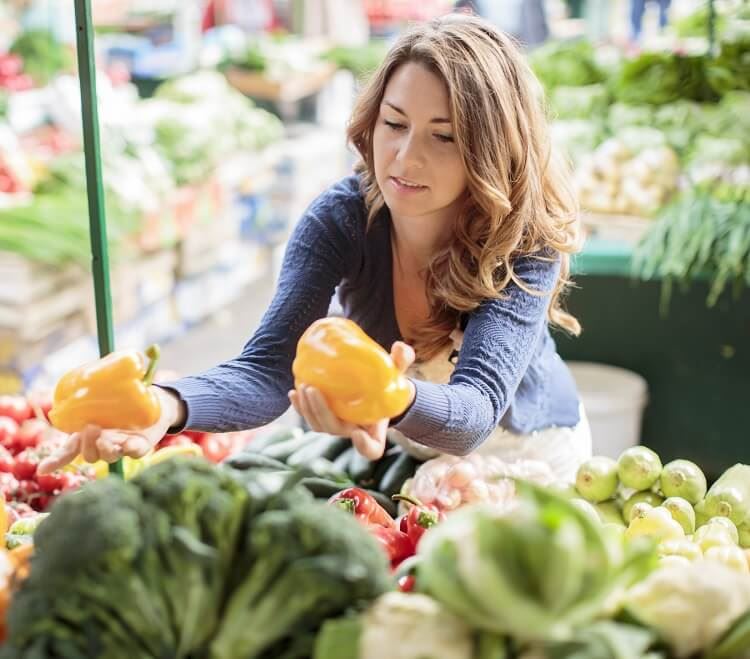 Young adult female shopping for produce