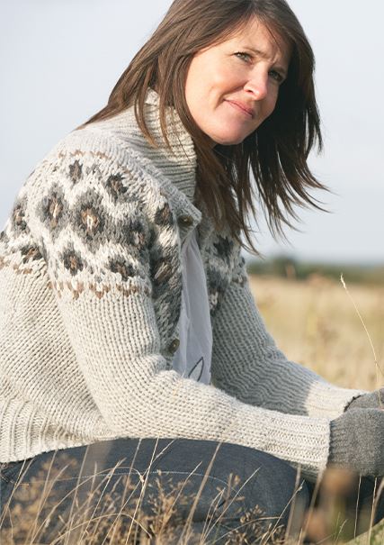 Adult caucasian woman kneeling in an open field