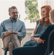 Group of adults sitting around in a circle having a discussion