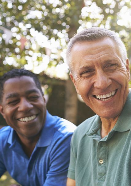 general-4.b4.delayed African American and Caucasian adult males smiling mid conversation