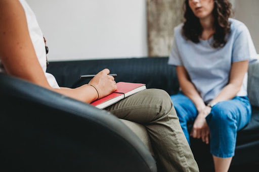 Doctor (therapist) sitting with female patient Doctor (therapist) sitting with female patient