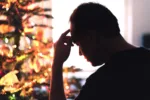 sad-on-christmas-unhappy-lonely-or-tired-man-with-stress-grief-or-depression-family-fight-loneliness-frustration-or-money-problem-on-xmas-sick-person-with-flu-pain-and-headache-on-holiday-stockpack-gettyimages Sad on Christmas. Unhappy, lonely or tired man with stress, grief or depression. Family fight, loneliness, frustration or money problem on Xmas. Sick person with flu, pain and headache on holiday