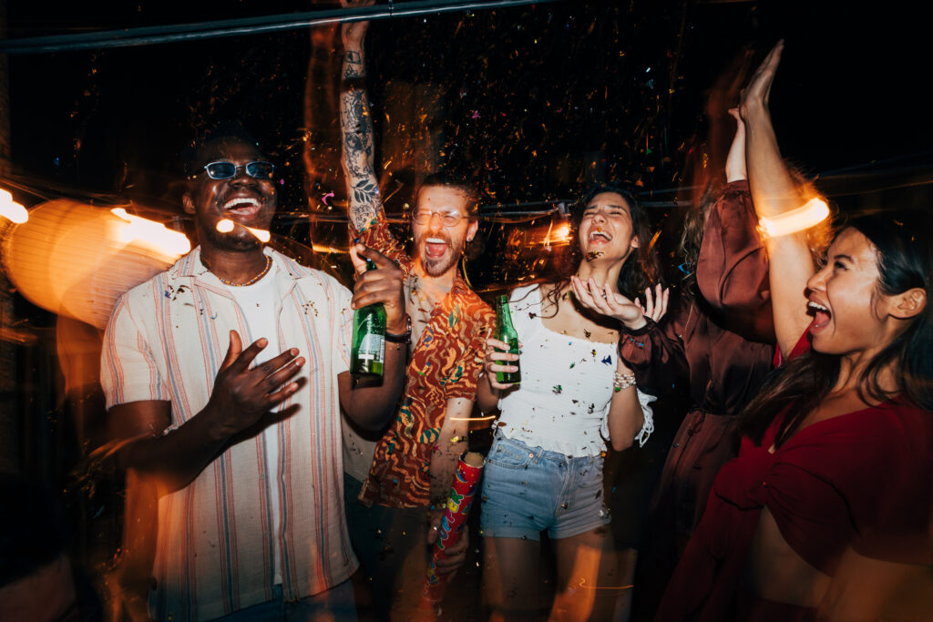 Group of young adults partying consuming alcohol