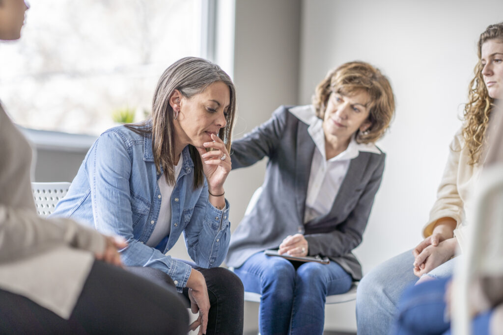 woman experiencing irritable discontent in group recovery session