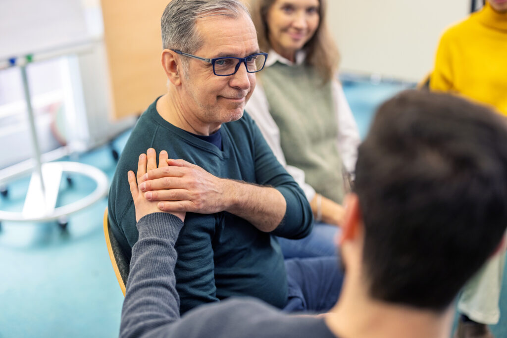 Man getting emotional support during treatment for substance use