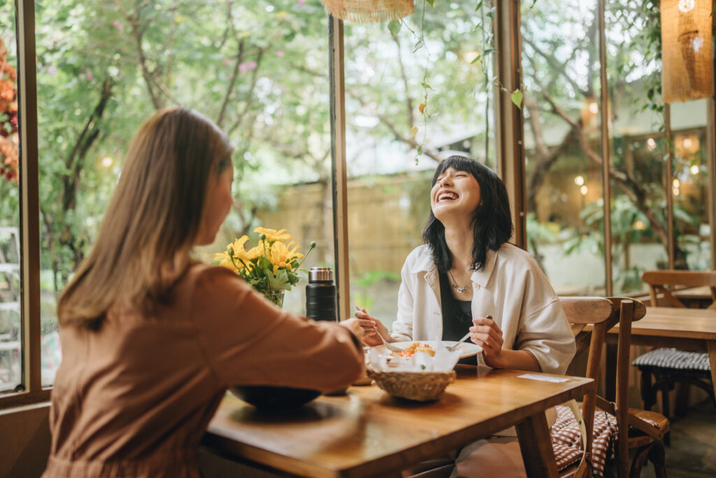A pair of friends enjoying a delicious meal together as a support group for each other